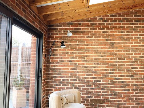 02 Main space - Red Brick, timber, Soho Home armchair