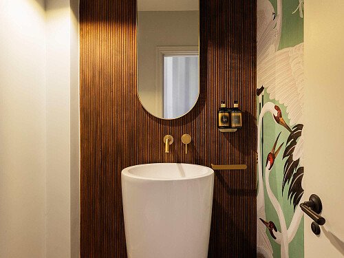 Cloakroom_Guest WC_Freestanding Basin_Fluted Wood Panelling_Oval Mirror_Gucci Wallpaper_Designer finishes_Boutique style