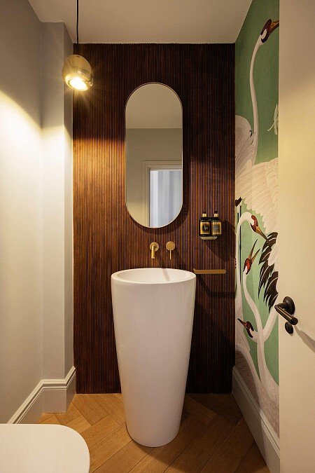 Cloakroom_Guest WC_Freestanding Basin_Fluted Wood Panelling_Oval Mirror_Gucci Wallpaper_Designer finishes_Boutique style
