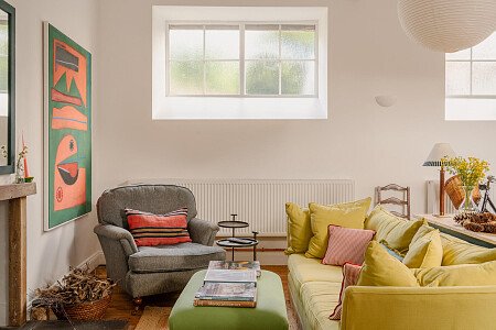 sitting room, yellow sofa, abstract art, fireplace, vaulted ceilings, rustic framhouse, open plan living