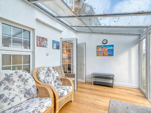 Bright conservatory with modern furnishings